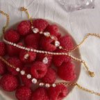 Clear stone bracelets displayed on raspberries