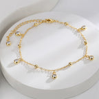 beaded zirconia drop anklet arranged on a white display
