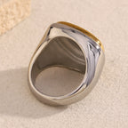 underside view of broad sculptural stainless steel signet ring