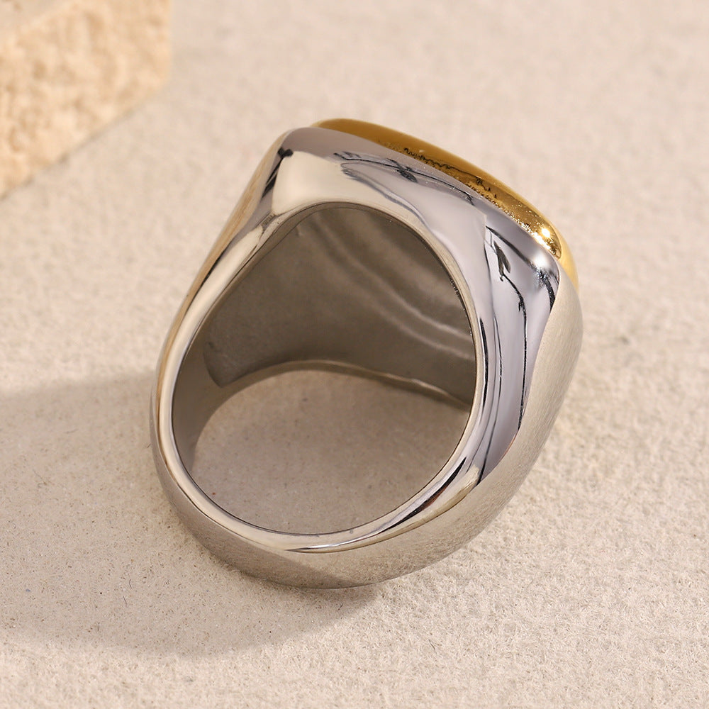 underside view of broad sculptural stainless steel signet ring