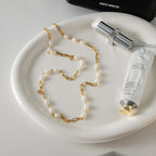 Freshwater pearl stainless steel necklace in a tabletop layout