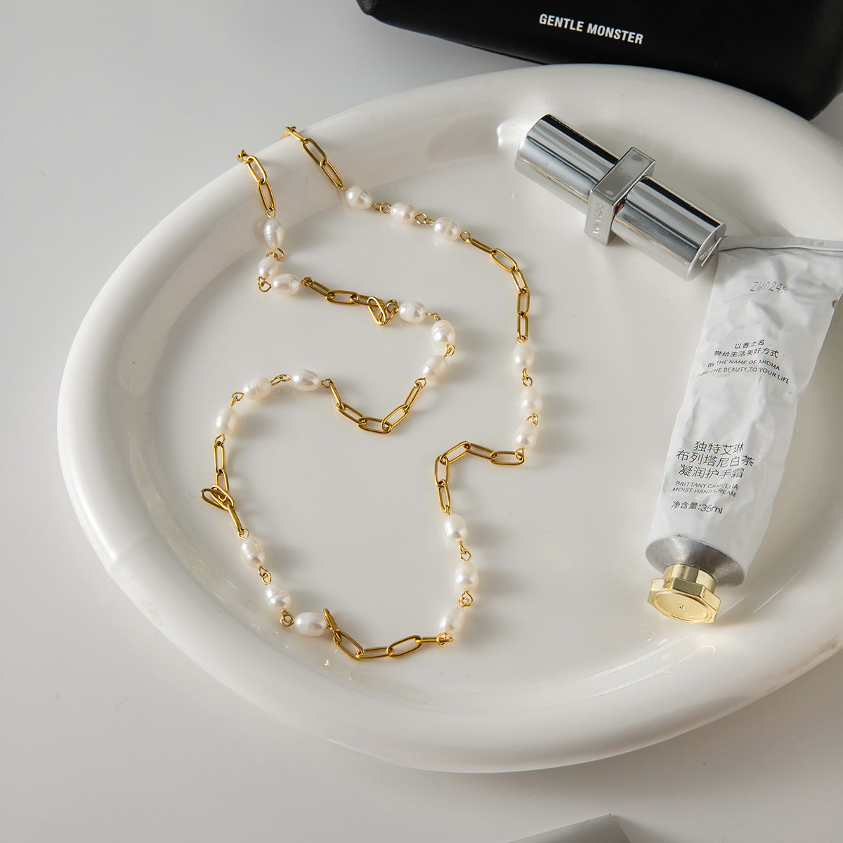 Freshwater pearl stainless steel necklace in a tabletop layout