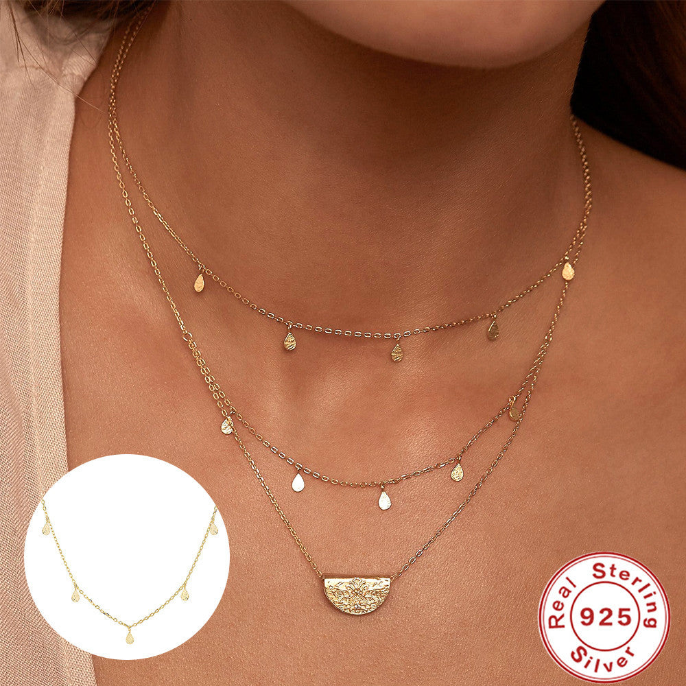 close styling view of the delicate gold plated teardrop necklace