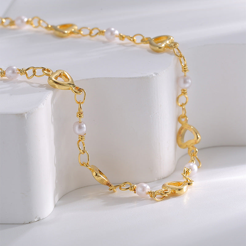 close-up of white beads and polished open-heart stations