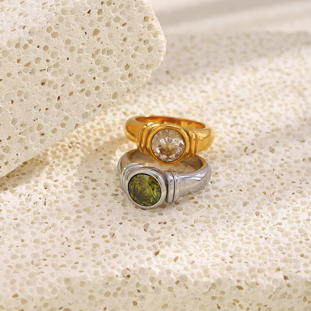 paired stainless steel round-stone rings in gold and silver finishes