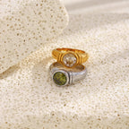paired stainless steel round-stone rings in gold and silver finishes