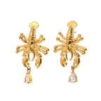 Detailed lobster earrings with clear drops on white