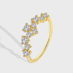 isolated gold plated brass ring with scattered clear-stone cluster