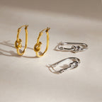 Gold and silver tone elongated knot hoops