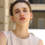 gold plated and silver chain hoop earrings worn on the ear