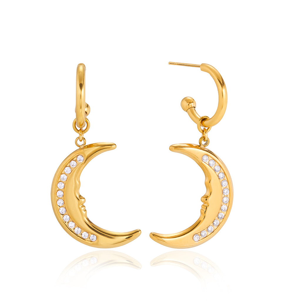 front and side views of clear stone crescent moon earrings