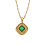 isolated gold plated square pendant necklace with a green stone