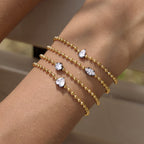 Four clear stone shapes worn together