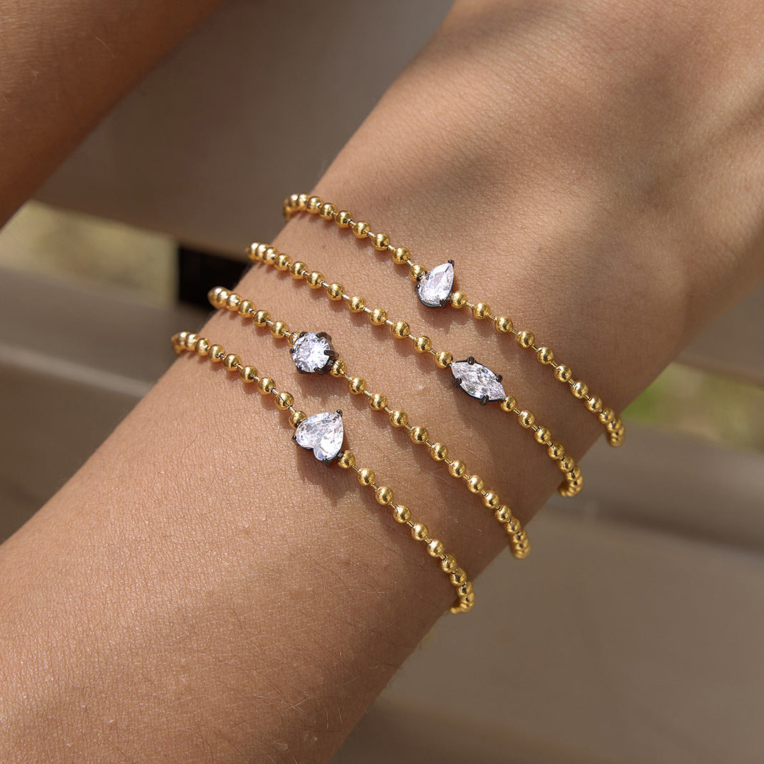 Four clear stone shapes worn together