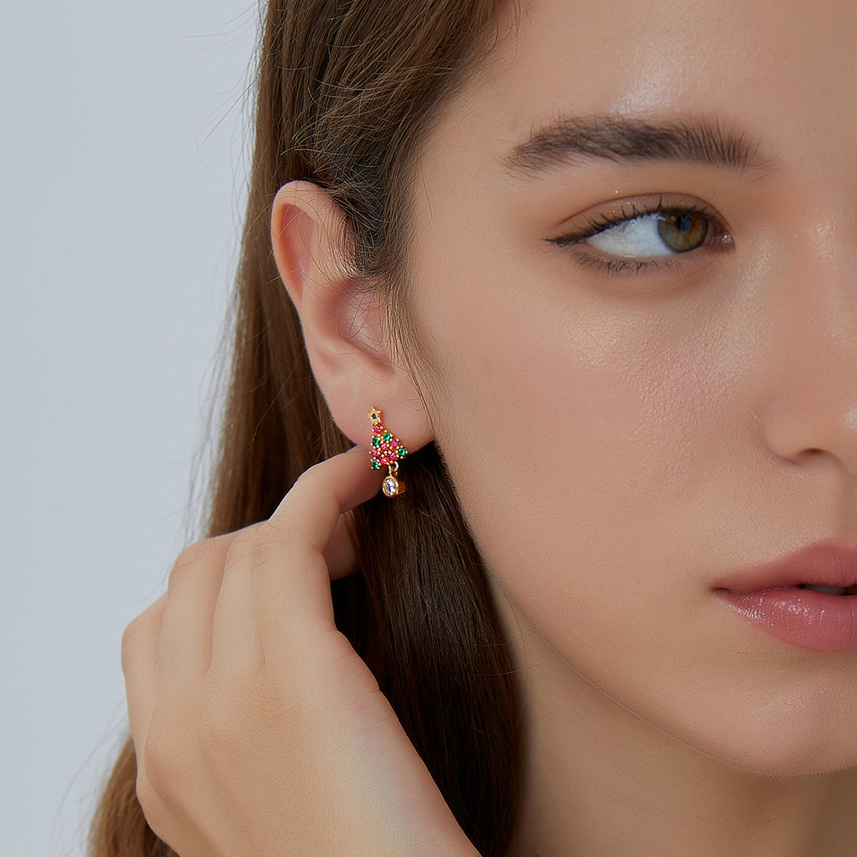Small colorful Christmas tree drop earrings shown worn