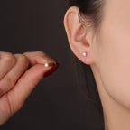 small polished silver star ball-back stud worn on the ear