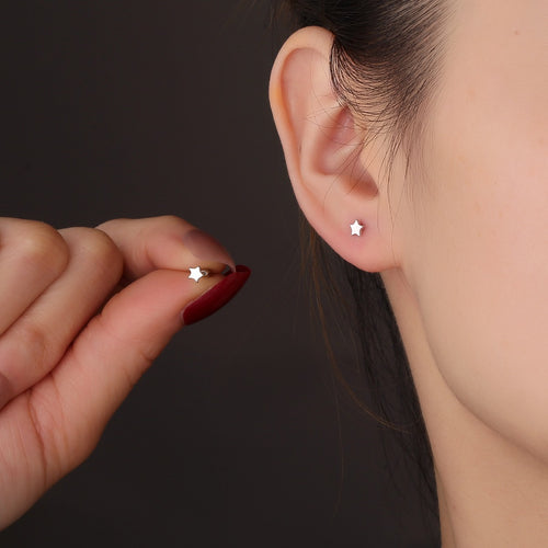 small polished silver star ball-back stud worn on the ear