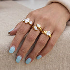 Three clear-stone statement rings worn together