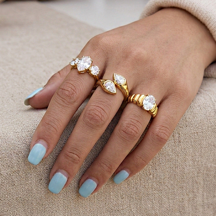 Three clear-stone statement rings worn together