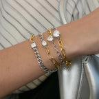 Two-tone clear stone bracelets layered on a wrist