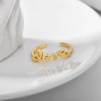 gold plated message ring displayed on a white dish