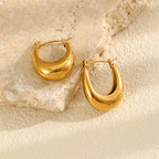 Gold plated U-shaped hoops resting on stone