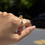 Clear resin ball ring shown in sunlight on a finger