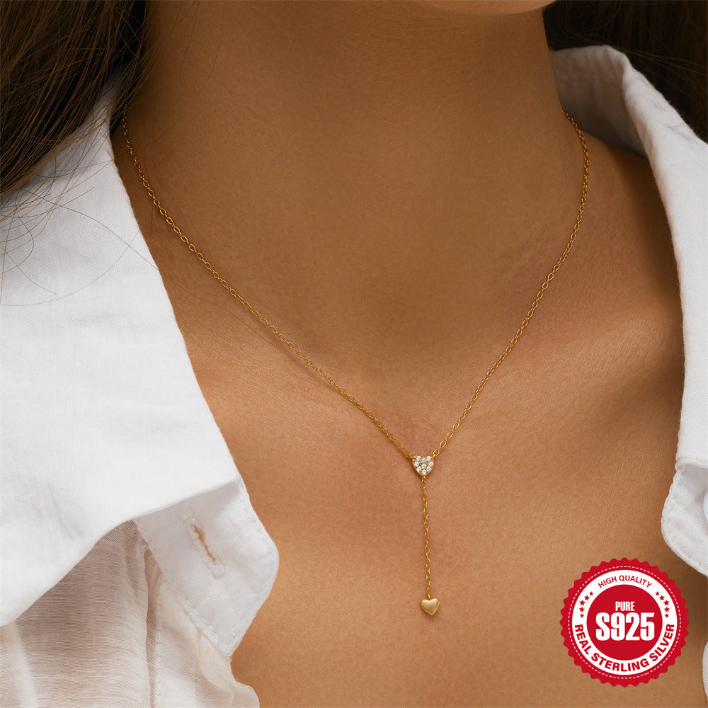 model wearing the gold plated zirconia heart drop necklace