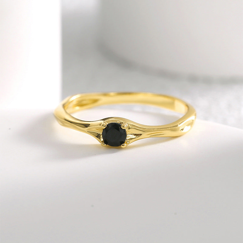 front view of slim gold plated black stone solitaire ring