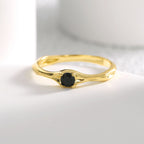 front view of slim gold plated black stone solitaire ring
