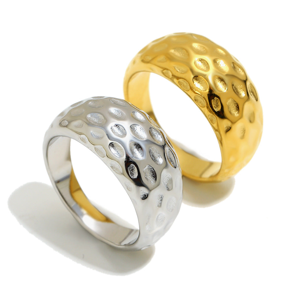 isolated pair of gold plated and silver hammered dome rings
