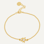 gold plated clear stone turtle station bracelet on white