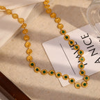 close view of repeating textured medallions and round green stones