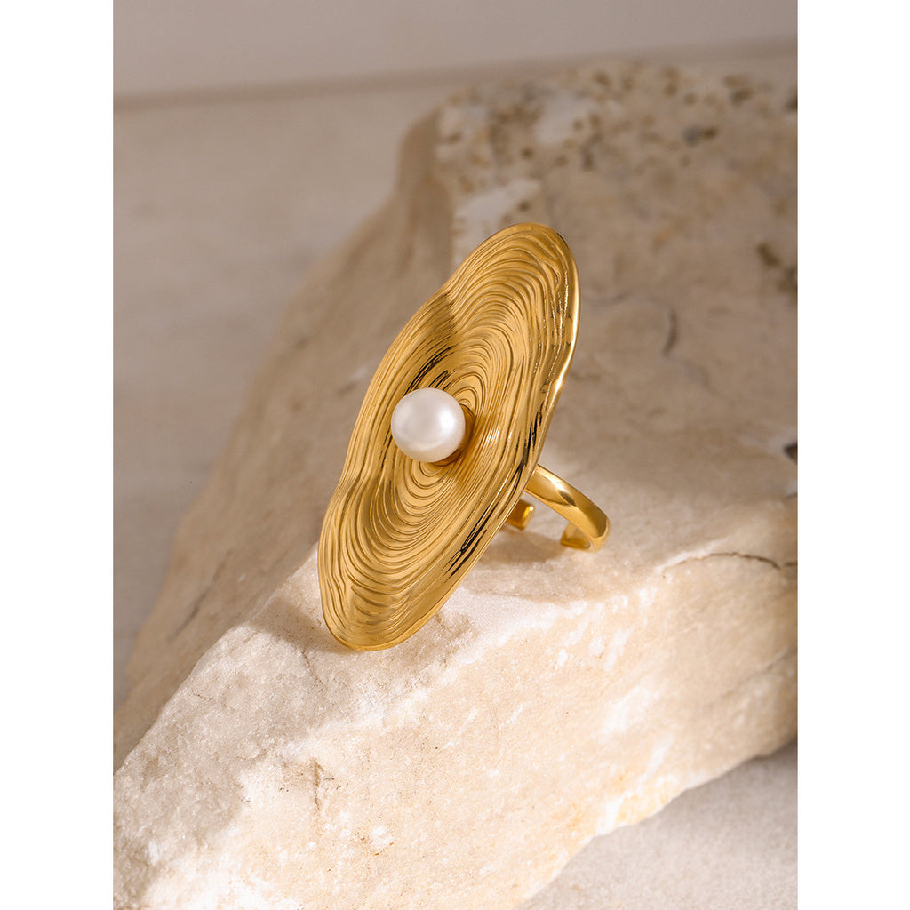 Gold plated oval disc ring with off-center white bead