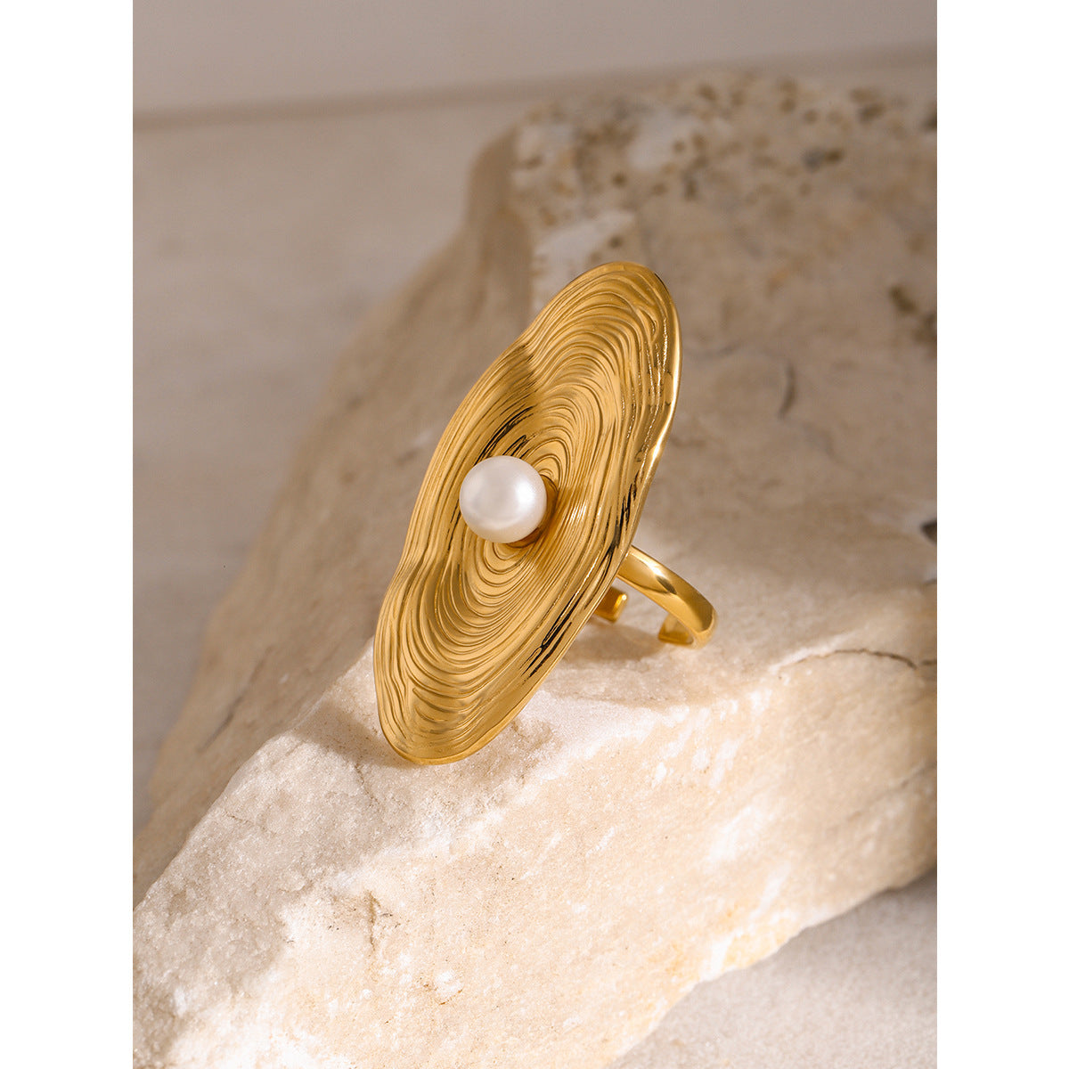 Gold plated oval disc ring with off-center white bead