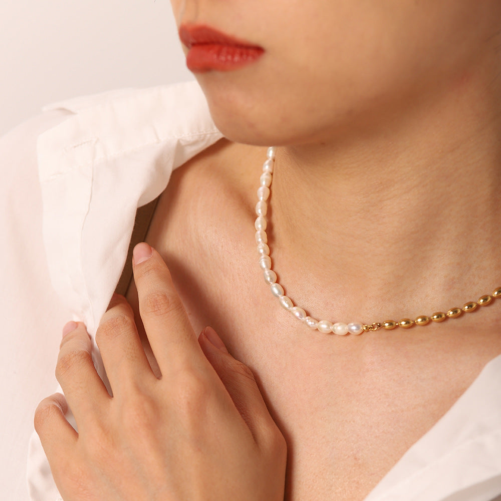 Close-up of the split white and gold bead necklace