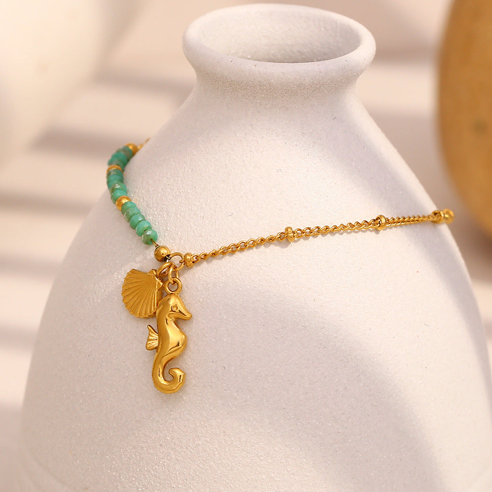Gold Plated Stainless Steel Green Bead Seahorse and Shell Bracelet — seahorse charm close-up