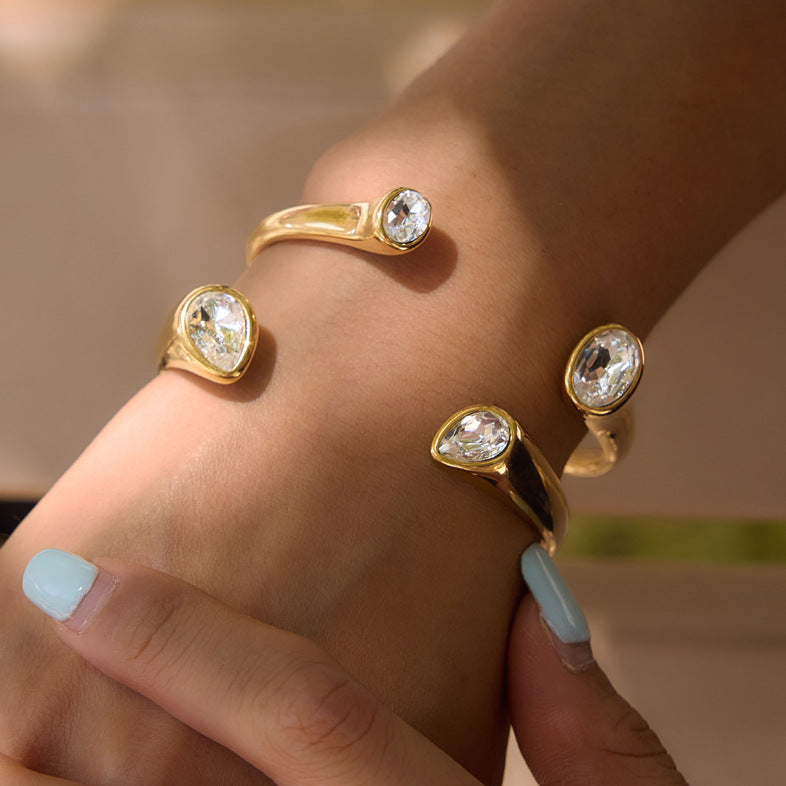 Two clear-stone cuff designs worn on wrist