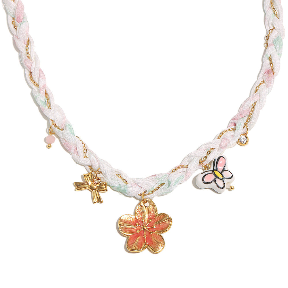 Full ribbon necklace with three decorative charms