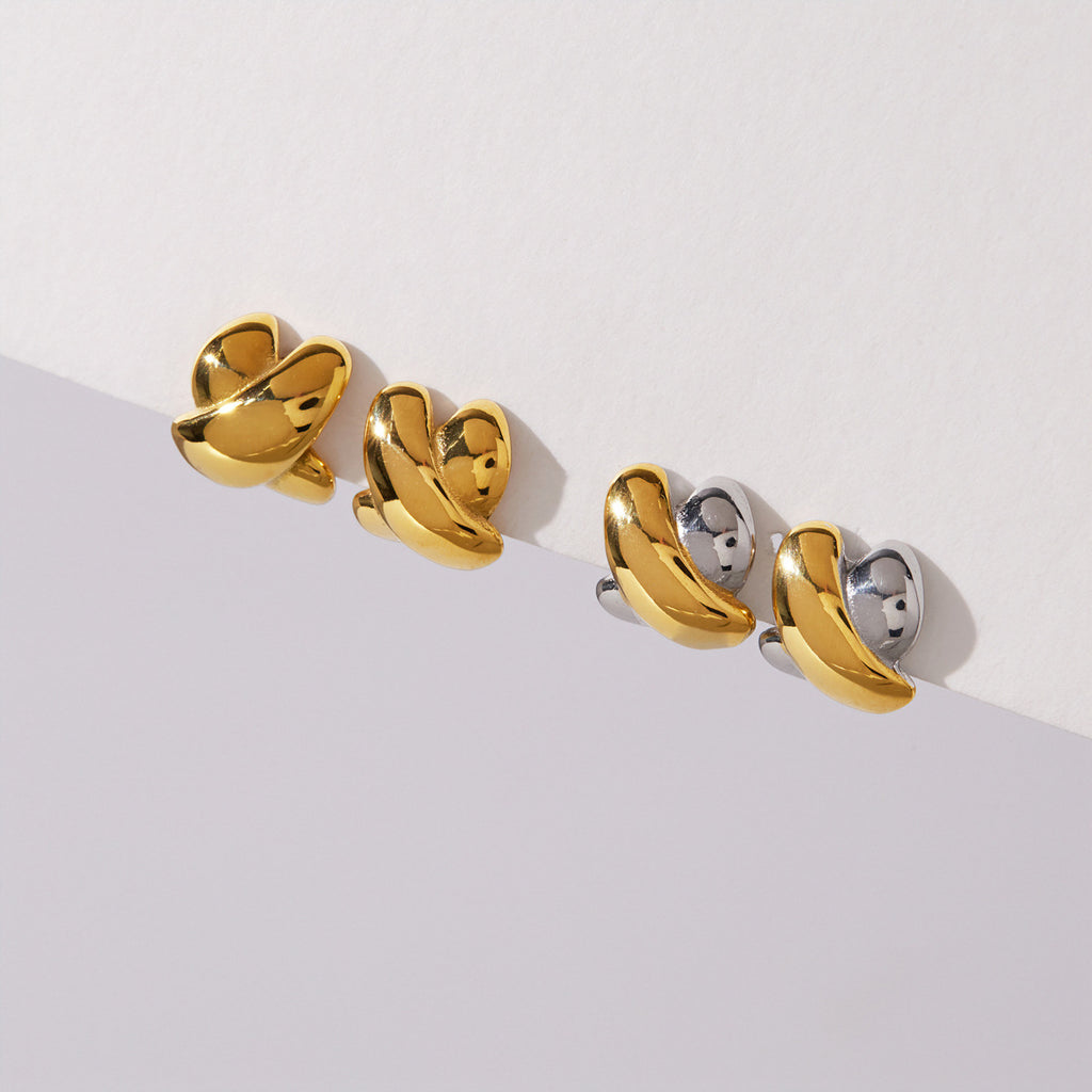 Gold-tone and two-tone crossed studs displayed together