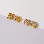 Gold-tone and two-tone crossed studs displayed together