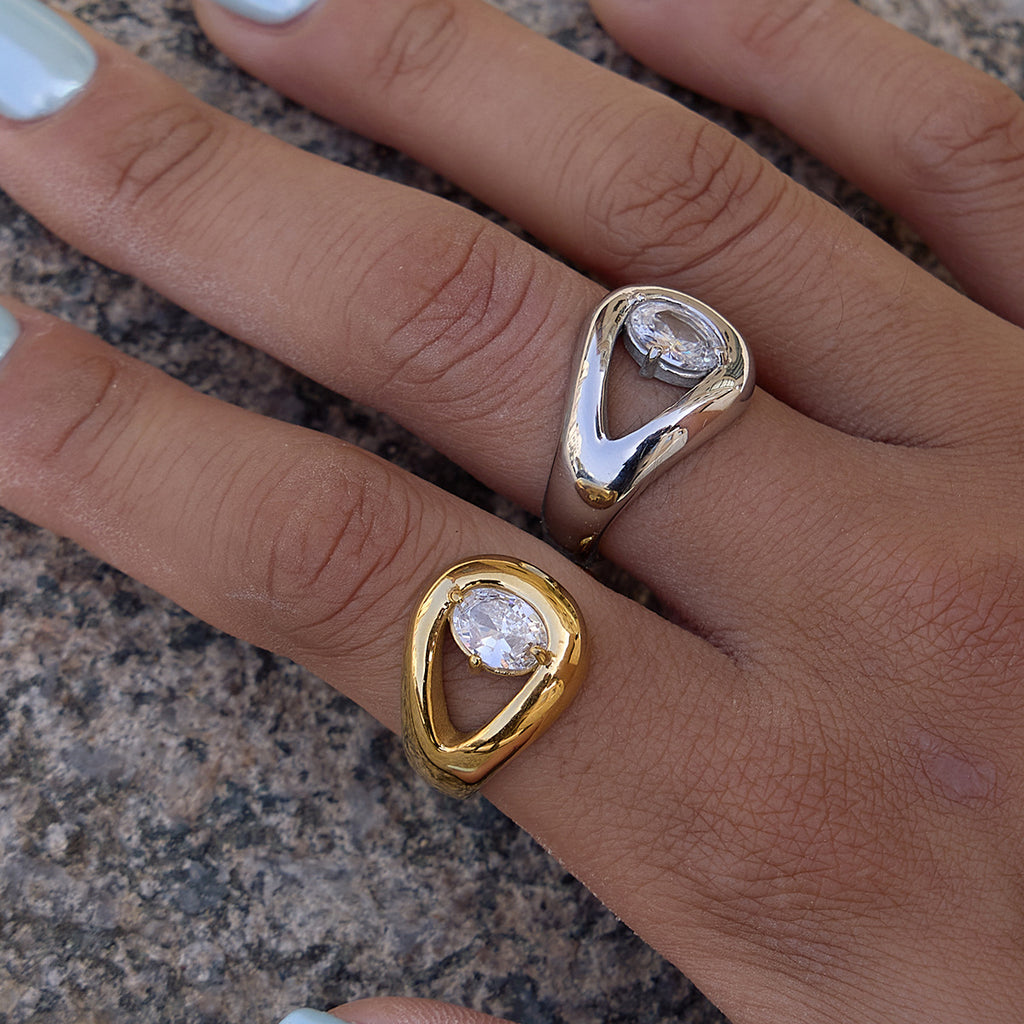 Two sculptural pear stone rings worn together