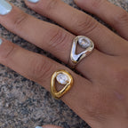 Two sculptural pear stone rings worn together