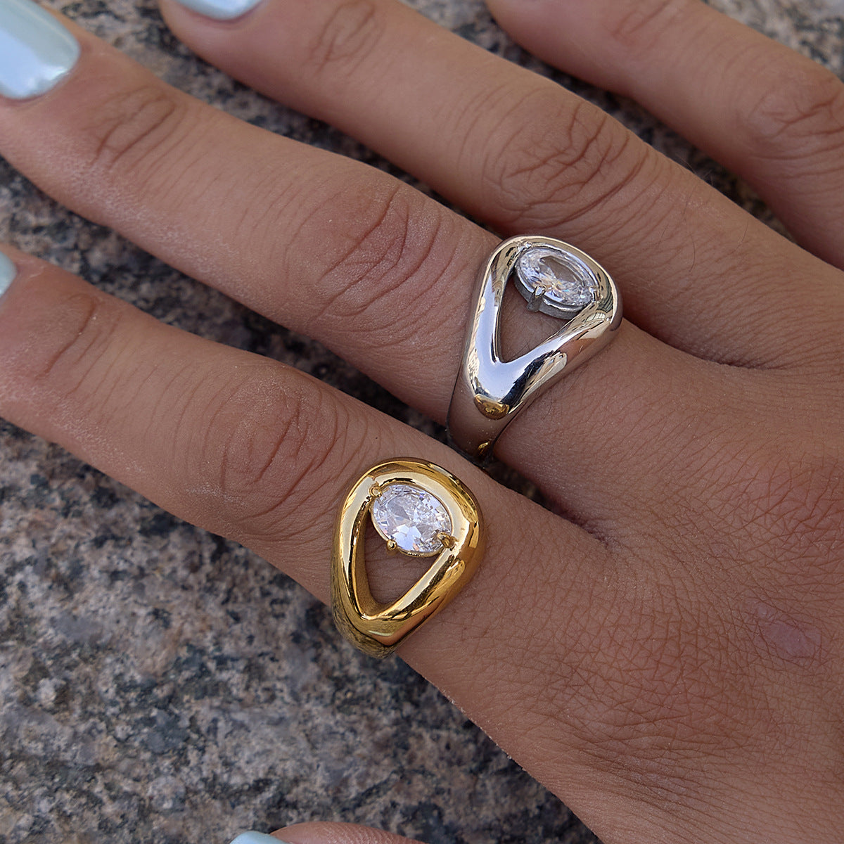 Two sculptural pear stone rings worn together