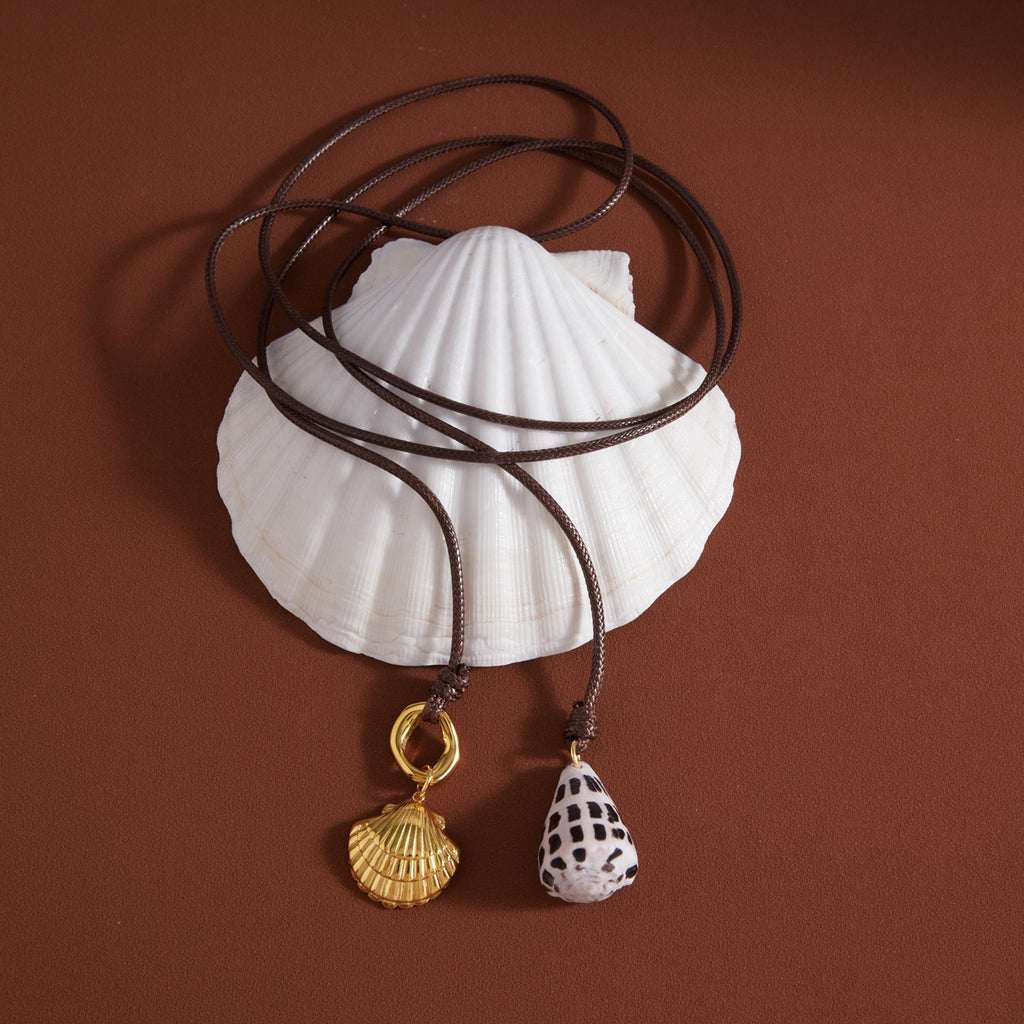 Brown cord necklace with patterned shell and metal shell ends