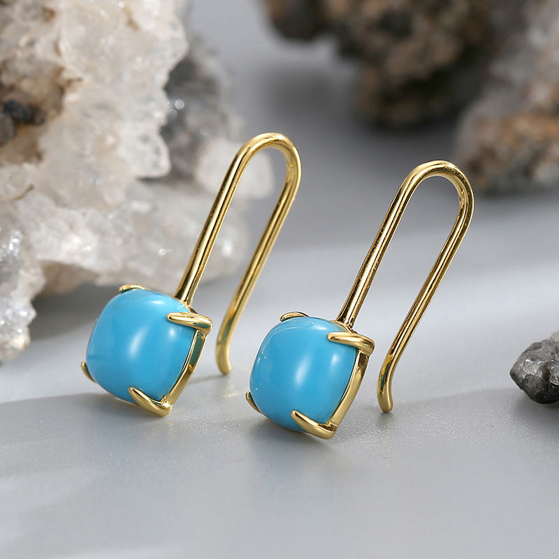 gold plated turquoise-color cabochon hook earrings on stone