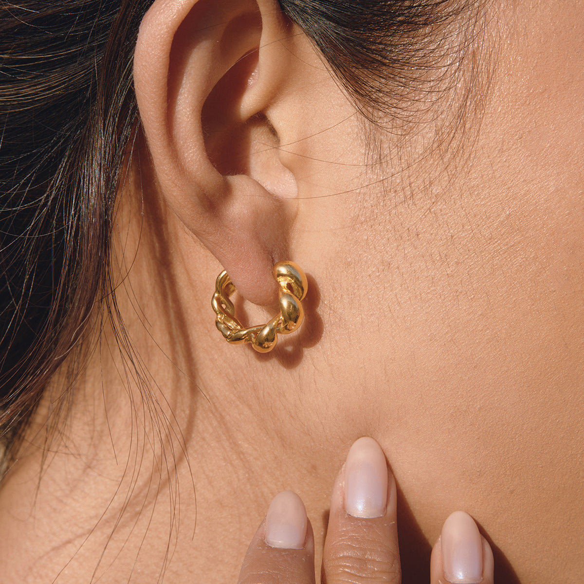 Rounded link hoop close-up on ear