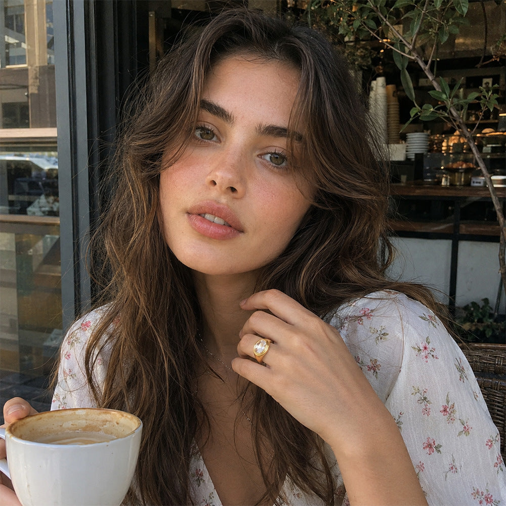 model wearing gold plated oval clear-stone statement ring