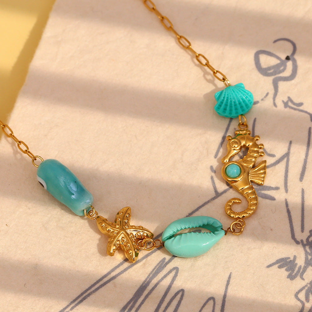 Fish starfish and seahorse necklace styled close-up