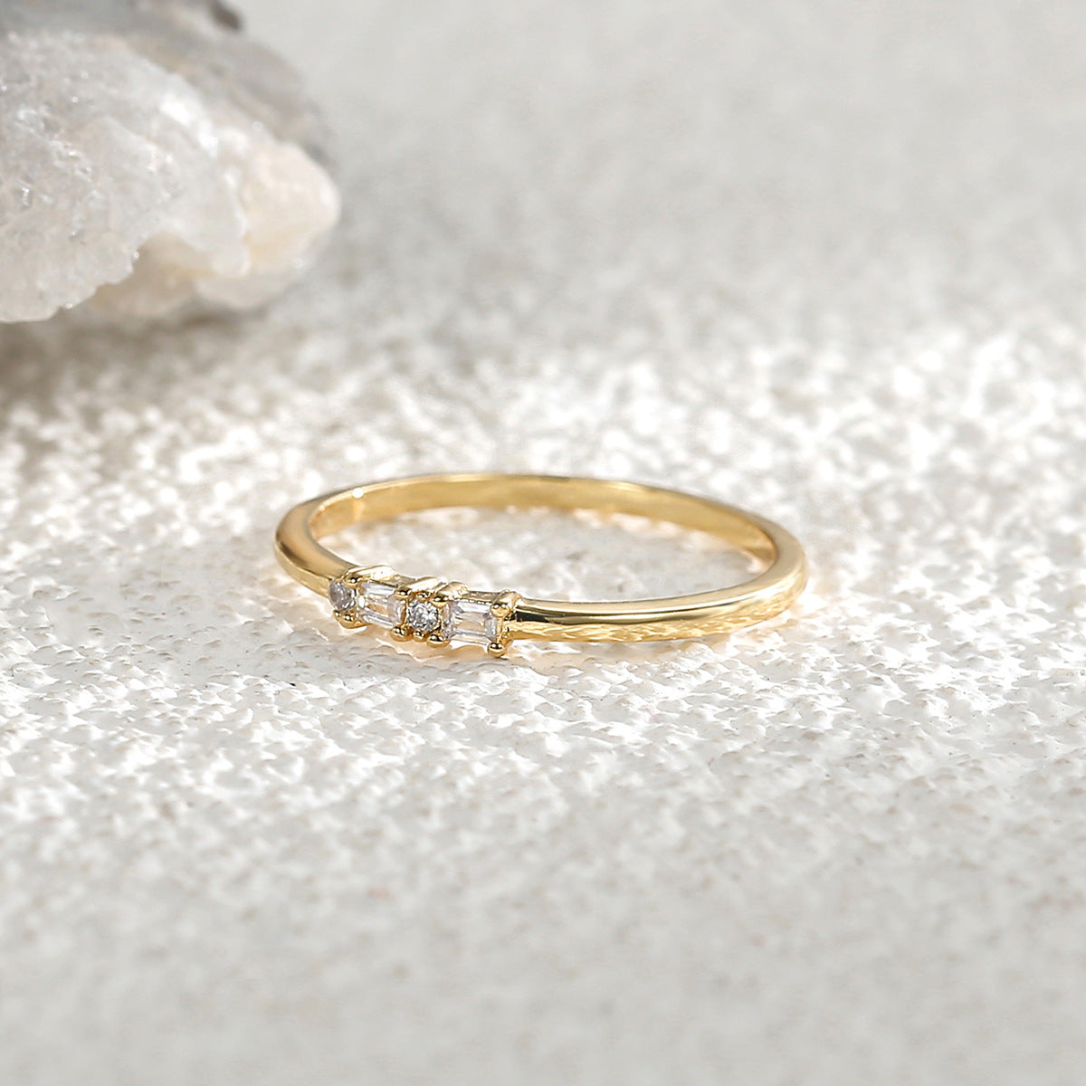 side view of slim mixed-cut clear-stone ring on crystal